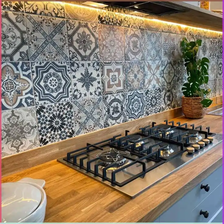 Blue and gray Moroccan patchwork backsplash behind a professional gas range